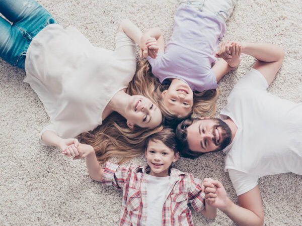 Family laying on the carpeted floor in Cape Coral, FL
